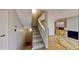 Carpeted staircase leading to a living area with tile floors and a fireplace at 1050 S Monaco Pkwy # 38, Denver, CO 80224