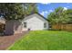 Private backyard with green lawn, shed, and wooden fence at 8801 E 16 Ave, Denver, CO 80220