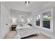 Cozy bedroom featuring windows, hardwood flooring, and ample natural light at 8801 E 16 Ave, Denver, CO 80220