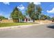 Quaint single-story home with wood fence, green lawn, and easy street access on a beautiful day at 8801 E 16 Ave, Denver, CO 80220