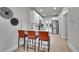 Contemporary kitchen with white cabinets, sleek countertops, stainless steel appliances, and modern chairs at 8801 E 16 Ave, Denver, CO 80220