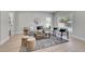 Bright and airy living room featuring modern furniture, neutral tones, and a large window at 8801 E 16 Ave, Denver, CO 80220