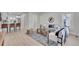 Open concept living area with seamless flow to the kitchen, modern furniture, and hardwood flooring at 8801 E 16 Ave, Denver, CO 80220