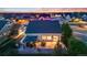 An aerial view shows the home's location next to the golf course and highlights the expansive green space at 19688 E 52Nd Ave, Denver, CO 80249