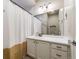 Bright bathroom boasts a stylish vanity with ample storage, complemented by a framed mirror and modern lighting fixtures at 19688 E 52Nd Ave, Denver, CO 80249