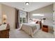Cozy bedroom features carpet floors, a comfortable bed, and natural light from the window, creating a warm retreat at 19688 E 52Nd Ave, Denver, CO 80249