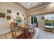 Traditional dining room with wood table, rug, elegant lamps, and a sliding glass door to the patio at 19688 E 52Nd Ave, Denver, CO 80249