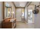 Bright foyer with wood floors, console table, and mirror at 19688 E 52Nd Ave, Denver, CO 80249