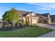 Landscaped front of house features a lawn, plants, and shrubs at 19688 E 52Nd Ave, Denver, CO 80249