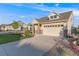 Inviting home with stone accents, two-car garage, and professionally landscaped front yard at 19688 E 52Nd Ave, Denver, CO 80249