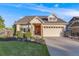 Well-maintained home with a manicured lawn and a welcoming two-car garage in a suburban setting at 19688 E 52Nd Ave, Denver, CO 80249