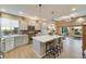 Bright kitchen features a large island, stainless steel appliances, and a view of the backyard at 19688 E 52Nd Ave, Denver, CO 80249