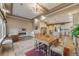 Open-concept living space with a dining area, kitchen, fireplace, and comfortable seating at 19688 E 52Nd Ave, Denver, CO 80249
