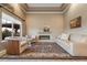 Bright living room featuring a fireplace, plush seating, large windows, and scenic views at 19688 E 52Nd Ave, Denver, CO 80249