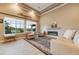 Bright living room featuring a fireplace, plush seating, large windows, and scenic views at 19688 E 52Nd Ave, Denver, CO 80249
