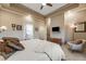 Spacious main bedroom with an ensuite bathroom, TV, and comfortable seating area at 19688 E 52Nd Ave, Denver, CO 80249