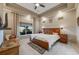 Serene main bedroom boasts a tray ceiling, ceiling fan, and a picturesque window view at 19688 E 52Nd Ave, Denver, CO 80249
