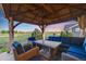 Inviting outdoor seating area with comfortable chairs, a table, and a pergola, perfect for enjoying the serene views at 19688 E 52Nd Ave, Denver, CO 80249
