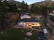 Scenic aerial shot of a home featuring hot tub, patio, stone path, and mature landscaping at 2571 Sw Grapevine Rd, Idledale, CO 80453