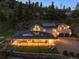 Aerial view of home with well-manicured lawn, covered porches, and solar panels at 2571 Sw Grapevine Rd, Idledale, CO 80453