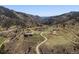 Majestic aerial view of home nestled among rolling hills and mountains at 2571 Sw Grapevine Rd, Idledale, CO 80453