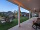 Inviting covered back porch with lounge chairs overlooking lush greenery and scenic mountain views at 2571 Sw Grapevine Rd, Idledale, CO 80453