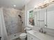 Bright bathroom with a marble tiled shower, updated fixtures, and a large vanity at 2571 Sw Grapevine Rd, Idledale, CO 80453