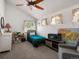 Bright bedroom features a ceiling fan, natural light, comfortable chair, and charming decor at 2571 Sw Grapevine Rd, Idledale, CO 80453