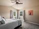 Cozy bedroom with a ceiling fan, two large windows, and plush carpet for a comfortable living space at 2571 Sw Grapevine Rd, Idledale, CO 80453