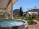 Relax in this luxurious hot tub with mountain views and a greenhouse next to a stone paver patio at 2571 Sw Grapevine Rd, Idledale, CO 80453