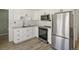 Updated kitchen featuring stainless steel appliances, white cabinets, and modern finishes at 2571 Sw Grapevine Rd, Idledale, CO 80453
