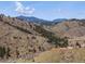 Dramatic landscape showcasing hills and valleys and winding dirt trail at 2571 Sw Grapevine Rd, Idledale, CO 80453