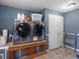 Bright laundry room with tile floors, folding counter, front loading machines, and ample storage space at 2571 Sw Grapevine Rd, Idledale, CO 80453