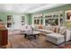 Spacious living room with a large sectional sofa, round coffee table, and plenty of natural light at 2571 Sw Grapevine Rd, Idledale, CO 80453