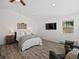 Bright main bedroom boasts a ceiling fan, wood-look flooring, a king bed and TV, and two recliners at 2571 Sw Grapevine Rd, Idledale, CO 80453