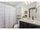 Bathroom features a shower, vanity, mirror, and a built-in cabinet at 5251 Central Park Blvd, Denver, CO 80238