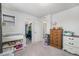 Bright bedroom features neutral carpeting, white walls, closet, and dressers at 5251 Central Park Blvd, Denver, CO 80238