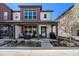 Inviting townhome with a covered front porch featuring comfortable seating and stylish decor at 5251 Central Park Blvd, Denver, CO 80238