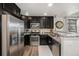 Well-equipped kitchen boasting stainless steel appliances, dark cabinetry, and functional layout at 5251 Central Park Blvd, Denver, CO 80238