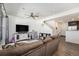 Cozy living room offering a large TV, comfortable sofa, and easy access to kitchen and stairs at 5251 Central Park Blvd, Denver, CO 80238