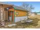 Cozy backyard featuring a building, a small table with chairs, and a spacious grassy area at 441 Johnson St, Frederick, CO 80530