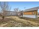 Cozy backyard featuring a building, a small table with chairs, and a spacious grassy area at 441 Johnson St, Frederick, CO 80530