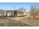 Cozy backyard featuring a building, a small table with chairs, and a spacious grassy area at 441 Johnson St, Frederick, CO 80530