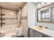 Bathroom with a shower-tub combo, stylish backsplash, and modern fixtures at 441 Johnson St, Frederick, CO 80530
