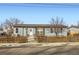 Charming exterior view of a light blue home with a picket fence and arched entrance at 441 Johnson St, Frederick, CO 80530