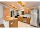 Kitchen featuring stainless steel appliances, wooden cabinets, and bright tile floor at 441 Johnson St, Frederick, CO 80530