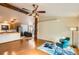 Open-concept living space with hardwood floors and views into kitchen and sitting area at 441 Johnson St, Frederick, CO 80530