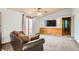 Cozy living room with plush carpeting and a large TV screen at 441 Johnson St, Frederick, CO 80530