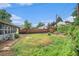 Generous backyard with a wood fence, shed, and mature trees providing privacy and potential for landscaping at 9590 Lowell Blvd, Westminster, CO 80031