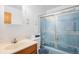 Compact full bathroom with functional vanity, toilet, and enclosed shower; vintage decor at 9590 Lowell Blvd, Westminster, CO 80031